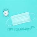 Disposable medical mask for protection against viruses and bacteria, pharmaceutical medicine pills and clock Royalty Free Stock Photo