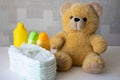 Disposable nappies, baby accessories and teddy bear Royalty Free Stock Photo
