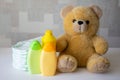 Disposable nappies, baby accessories and teddy bear Royalty Free Stock Photo