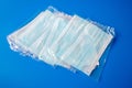 disposable new in packaging medical mask on a blue background