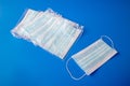 disposable new in packaging medical mask on a blue background
