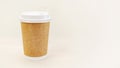 Disposable paper cup for coffee on light beige background. Royalty Free Stock Photo