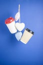 disposable paper flying coffee cups with textile hearts on a blue background hanging on. Takeaway coffee concept. I love coffee Royalty Free Stock Photo