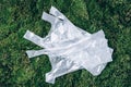 Disposable plastic bags on green moss, grass background. Pollution problem concept. Top view. Copy space. Environmental Royalty Free Stock Photo