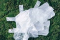 Disposable plastic bags on green moss, grass background. Pollution problem concept. Top view. Copy space. Environmental Royalty Free Stock Photo