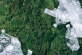 Disposable plastic bags on green moss, grass background. Pollution problem concept. Top view. Copy space. Environmental Royalty Free Stock Photo