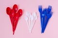 disposable plastic colored spoons and forks on a pink background, flatlay Royalty Free Stock Photo