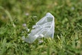 Disposable plastic cup discarded on meadow ground,envinronment waste pollution Royalty Free Stock Photo