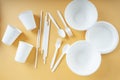 Disposable plastic cup, fork, spoon, bowl, pan,and straw over orange background Royalty Free Stock Photo