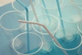 Disposable plastic cups on a blue and white background. Plastic straw tubules inside cups. Selective focus. Royalty Free Stock Photo