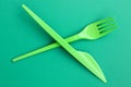 Disposable plastic cutlery green. Plastic fork and knife lie on