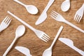 Disposable plastic cutlery on wooden table. Royalty Free Stock Photo
