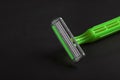 Disposable plastic razor on a black background. Close-up. Skin care concept Royalty Free Stock Photo