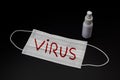 Disposable prevention mask with word virus written on red and bottle of disinfectant on black background