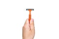 disposable razor orange color in a human hand