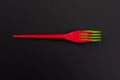 Disposable red and green plastic forks isolated on black Royalty Free Stock Photo