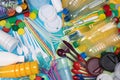 Disposable single use plastic objects such as bottles, cups, forks, spoons and drinking straws Royalty Free Stock Photo