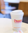 Dunkin donuts cup of hot coffee and sugar sachet on table