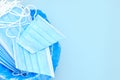 Disposable surgical mask is thrown to the trash bin on a blue background with copy space.  Coronavirus and quarantine is over. End Royalty Free Stock Photo