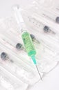 Disposable syringe with green liquid and needle Royalty Free Stock Photo