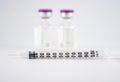 Disposable syringe on injection vials Royalty Free Stock Photo