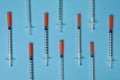 Disposable syringes on light blue background, flat lay Royalty Free Stock Photo