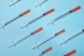 Disposable syringes on light blue background, flat lay Royalty Free Stock Photo