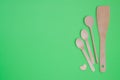 Disposable tableware set from natural materials, wooden spoon, Eco-friendly. Wooden spoons Eco concept on green background. Copy s Royalty Free Stock Photo