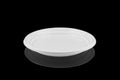 Disposable white plastic plate isolated on black background Royalty Free Stock Photo