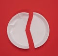 Disposable white plastic plate on a red background Royalty Free Stock Photo