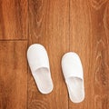 Disposable white slippers on hotel room floor