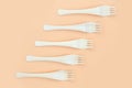Disposable wooden forks on orange background Royalty Free Stock Photo