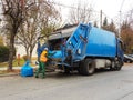 Disposal of fallen autumn leaves in the city. Collection and transportation of domestic garbage by municipal service employees. Co