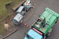 Disposal of municipal waste using a special car garbage truck, the garbage is loaded into the car Royalty Free Stock Photo