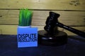Dispute Resolution write on sticky note and gavel. Wooden background. Law concept