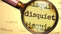 Disquiet and a magnifying glass on English word Disquiet to symbolize studying, examining or searching for an explanation and Royalty Free Stock Photo