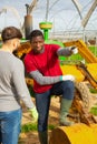 Disquieted african american gardener talking to friend Royalty Free Stock Photo