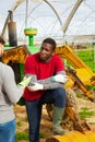 Disquieted african american gardener talking to friend Royalty Free Stock Photo