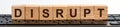 DISRUPT word made with building blocks jn the black keyboard