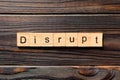 DISRUPT word written on wood block. DISRUPT text on wooden table for your desing, concept