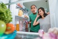 dissapointed couple while opening the fridge door Royalty Free Stock Photo