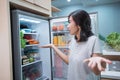 dissapointed woman while opening the fridge door Royalty Free Stock Photo