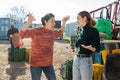 Dissatisfied Asian woman farmer reprimanding young female worker