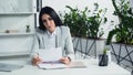 dissatisfied businesswoman looking at document in