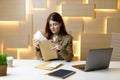 Dissatisfied businesswoman reads mail bills at workplace