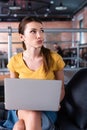 Dissatisfied businesswoman using laptop and looking