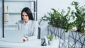 dissatisfied businesswoman using laptop in modern