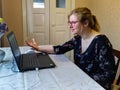 Dissatisfied european woman work on laptop at home