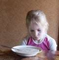 Dissatisfied girl with porridge plate