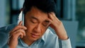 Dissatisfied male businessman client annoyed asian korean angry man talking mobile phone has misunderstanding problem Royalty Free Stock Photo